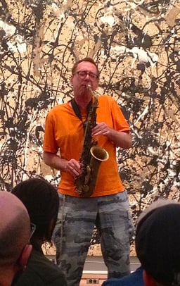 How does John Zorn typically categorize his music genre?