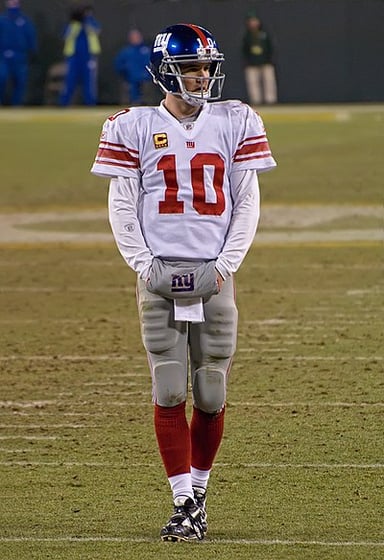 Which team did Eli Manning defeat twice in the Super Bowl?