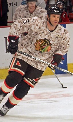 Who was the first player to have their number retired by the Chicago Blackhawks?