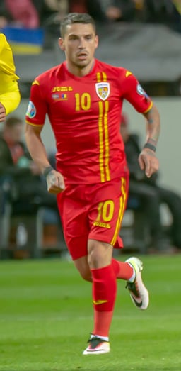 In which month and year did Stanciu make his senior international debut for Romania?