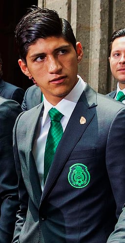 Which tournament did Alan Pulido not make any appearances due to disputes with Tigres UANL?