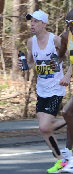In which world city did Galen Rupp record his personal best marathon time?