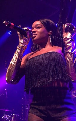 Which record label did Azealia first sign with at age 18?