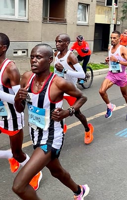 What is the full name of the Kenyan long-distance runner with the initials E.K.?