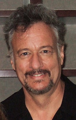 In which sci-fi television series did John de Lancie portray Frank Simmons?