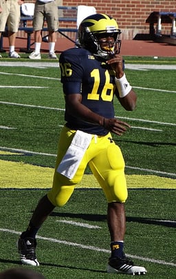 How many games did Robinson start as quarterback for the 2010 and 2011 Michigan Wolverines football teams?