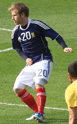 Which player did Bannan replace in his full Scotland debut match against Faroe Islands?