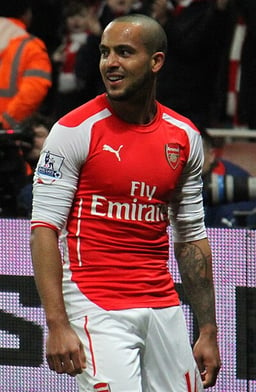 Who was Theo Walcott's manager at Arsenal?