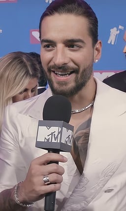 How old was Maluma when he released his debut album, Magia?