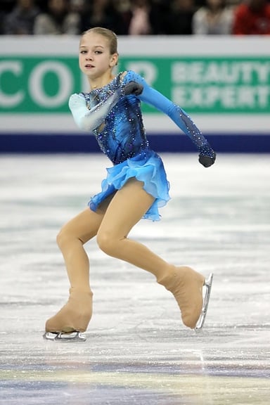 Alexandra Trusova was the first woman to land which quad jump in international competition?