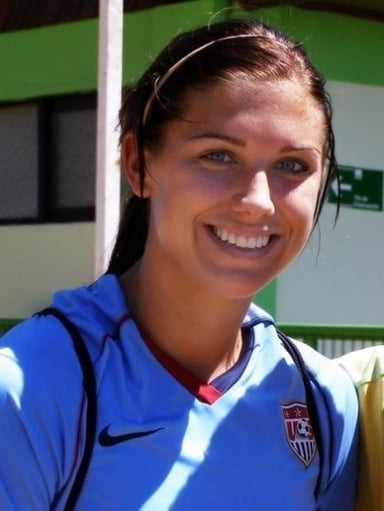 Which video game did Alex Morgan appear on the cover of alongside Lionel Messi?