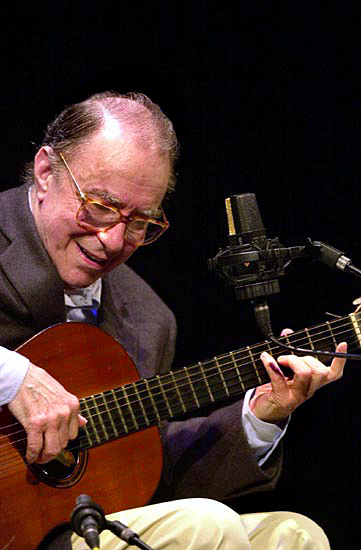 João Gilberto's smooth singing style is often described as?