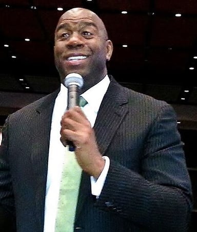 Which baseball team did Magic Johnson become a part-owner of in 2012?