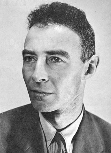 Which university did Oppenheimer hold academic positions at before working on the Manhattan Project?