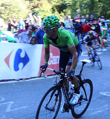 Which team was Alejandro Valverde competing for during his road racing career?