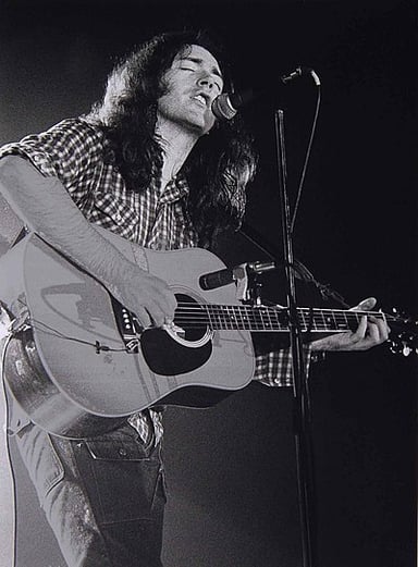 What type of guitar is Rory Gallagher famously associated with?