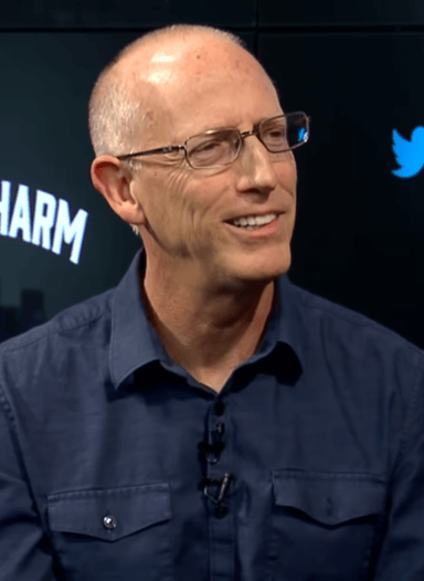 What type of company did Scott Adams work at before creating Dilbert?