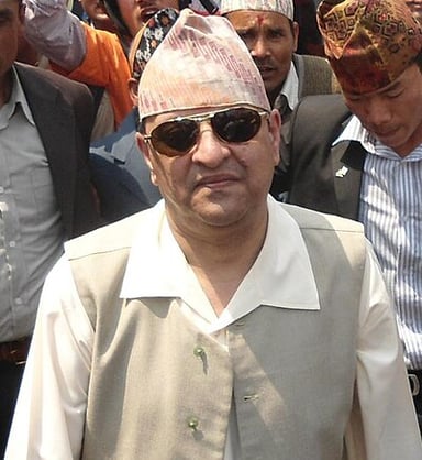 Gyanendra’s first reign was due to his grandfather taking political exile in which country?