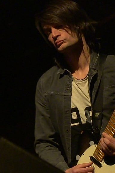 What instruments does Jonny Greenwood prominently play in his performances?