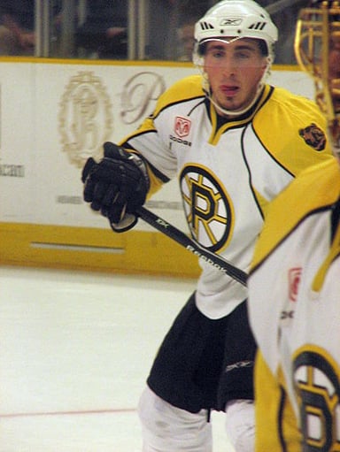 Who was Brad Marchand's childhood friend and future NHL player?