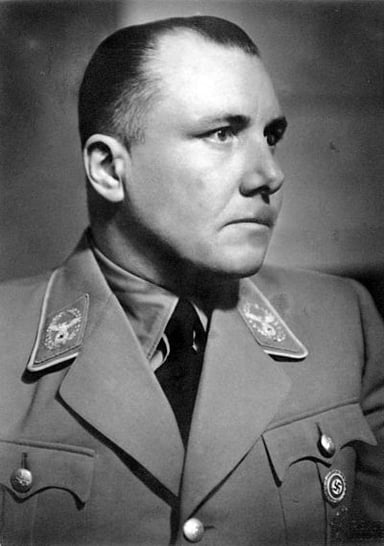 Who was the commandant of Auschwitz that Bormann aided in murder?