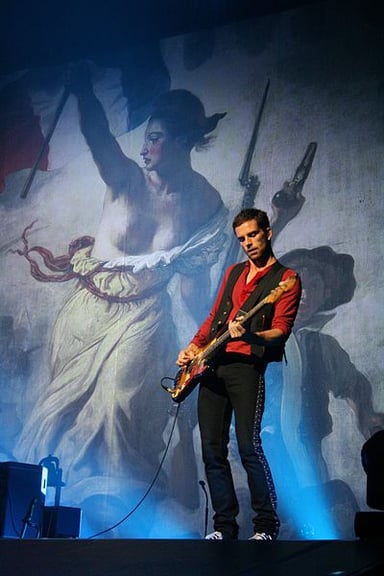 What other band is Guy Berryman a part of, besides Coldplay?