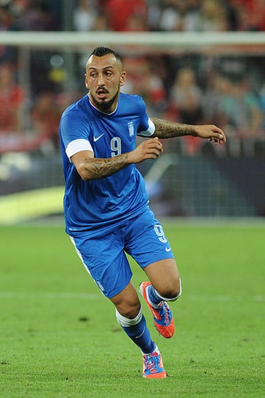 How many caps has Mitroglou earned for the Greece national team as of 2023?