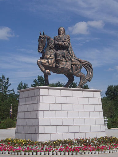 What was the name of the political and military council where Genghis Khan adopted his title?