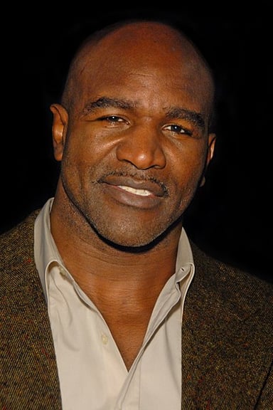 Which fighter was disqualified during a match with Holyfield for biting off part of his ear?