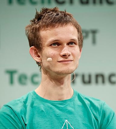 Which famous person has Buterin shared a stage with to discuss blockchain?