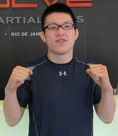 In which organization does Shinya Aoki currently compete?