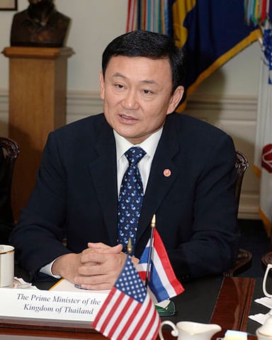 What is the religion or worldview of Thaksin Shinawatra?