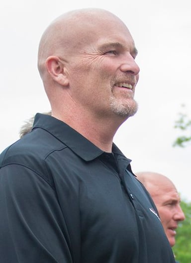 What event did Dan Quinn compete in during his college athletics, besides football?