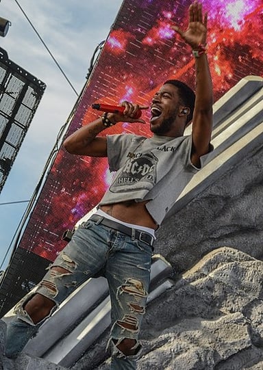 In which year did Kid Cudi earn his first number-one song on the US Billboard Hot 100 chart?