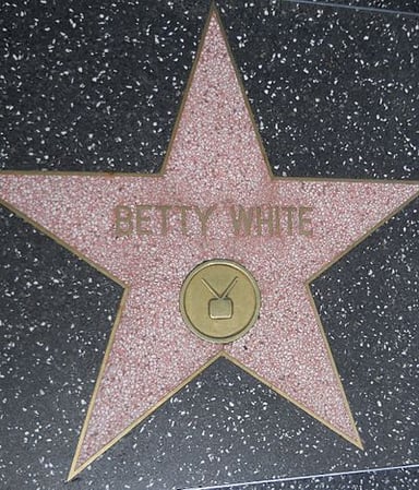 Which game show did Betty White become the first woman to receive the Daytime Emmy Award for Outstanding Game Show Host?
