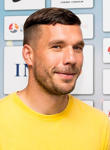 Which trophy did Lukas Podolski win with Arsenal in 2014?