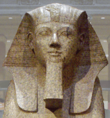 How was Hatshepsut depicted in statues and carvings?