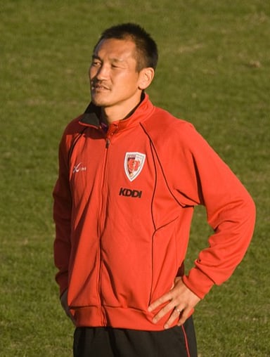 In which decade did Yutaka Akita make his debut as a professional footballer?