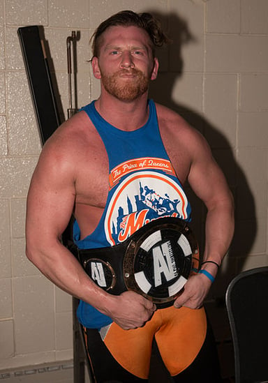 What is the real name of the wrestler known as Curt Hawkins?