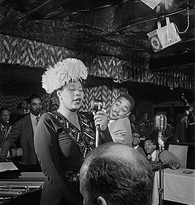In which famous Harlem venue did Ella Fitzgerald often perform with the Chick Webb Orchestra?