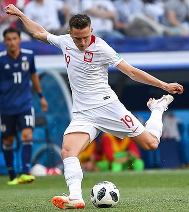 What is the primary color of the Poland national team jersey worn by Zieliński?
