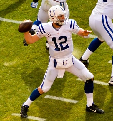 Which team did Luck beat in his first playoff game?