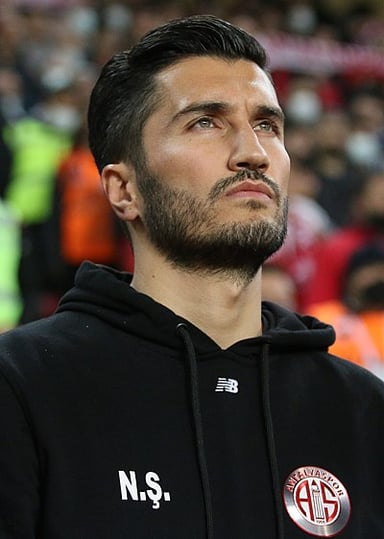 At what age did Şahin make his senior international debut for Turkey?