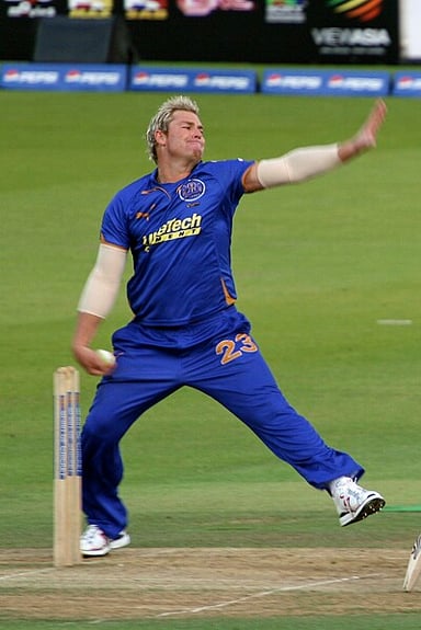 Where is the statue of Shane Warne bowling located?