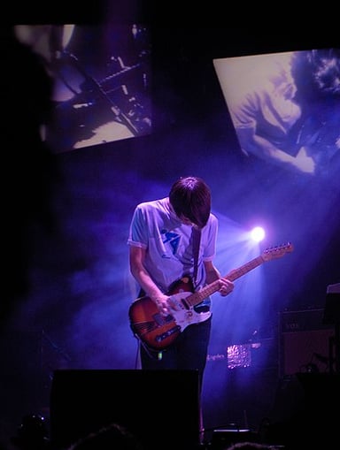 Which publication named Jonny Greenwood as one of the greatest guitarists?