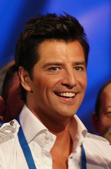 I'm curious about Sakis Rouvas's most well-known professions. Could you tell me what they are? [br](Select 2 answers)