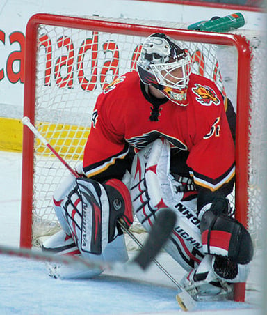 Who has the most wins by a goaltender in a Calgary Flames uniform?