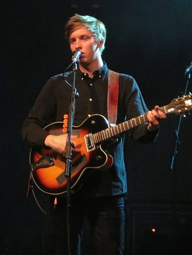 What instrument is George Ezra known for playing?