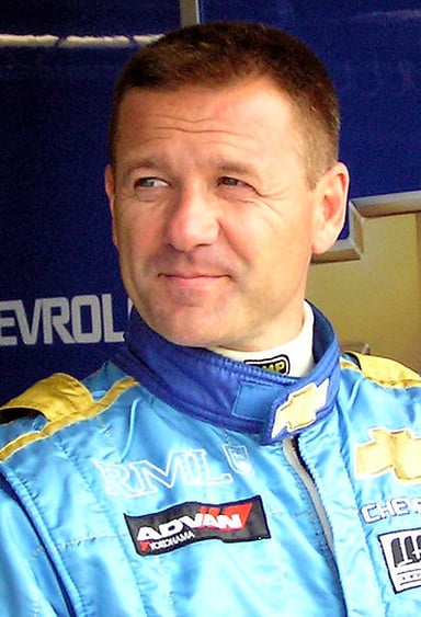 Which Italian car manufacturer is closely associated with Nicola Larini's racing career?