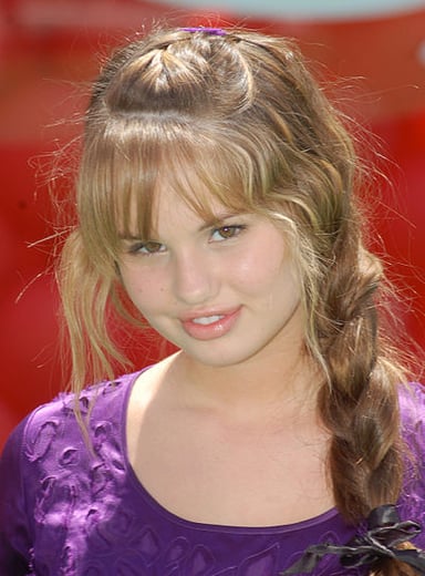 Has Debby Ryan contributed vocals to the soundtracks of her Disney projects?